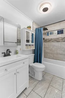 a bathroom with a sink toilet and shower