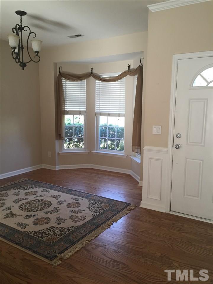 8425 Aztec Dawn Court Raleigh, NC 27613 - Photo 4 of 8 a view of empty room with wooden floor and fan