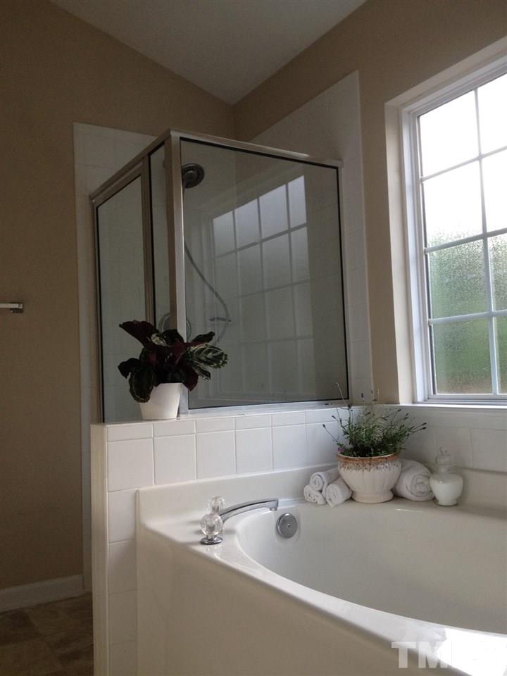 8425 Aztec Dawn Court Raleigh, NC 27613 - Photo 5 of 8 a bathroom with a sink and a mirror