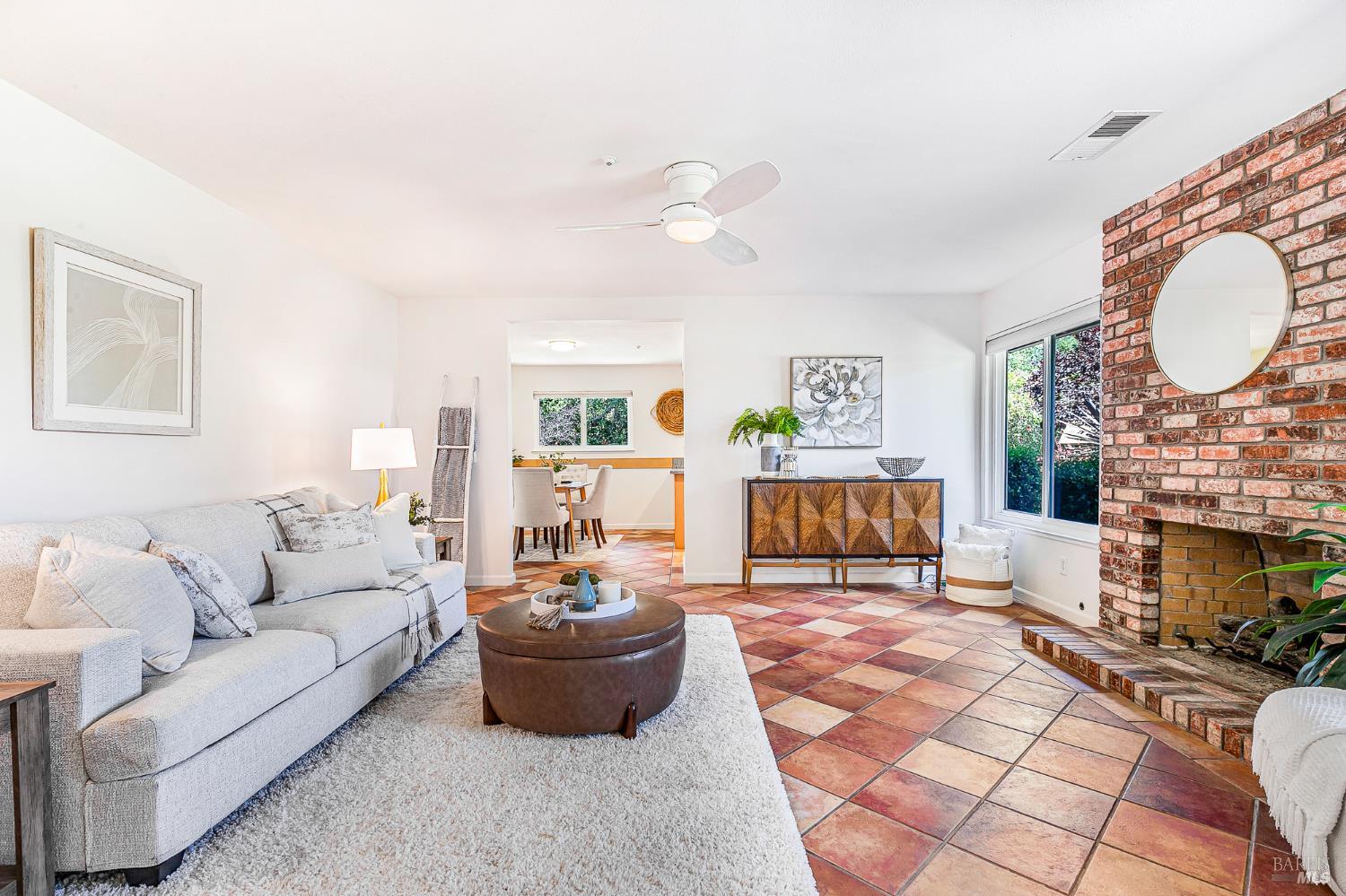 29 Woodgreen Street Santa Rosa, CA 95409 - Photo 4 of 42 a living room with furniture a fireplace and a large mirror