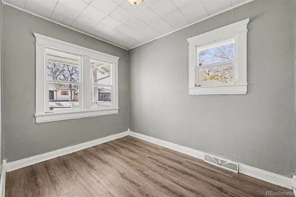 a view of room with window and wooden floor
