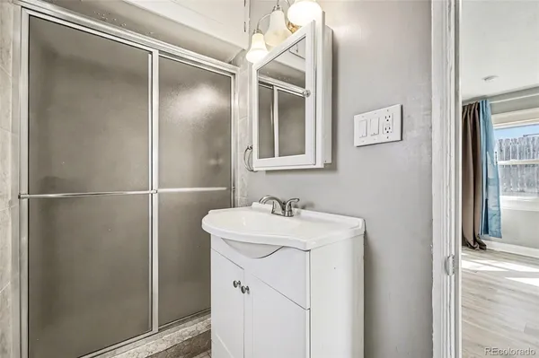a bathroom with a sink mirror and vanity