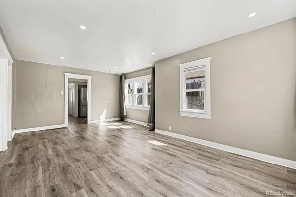 a view of a livingroom with wooden floor and a window