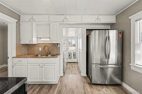 a kitchen with stainless steel appliances granite countertop a refrigerator and a stove top oven