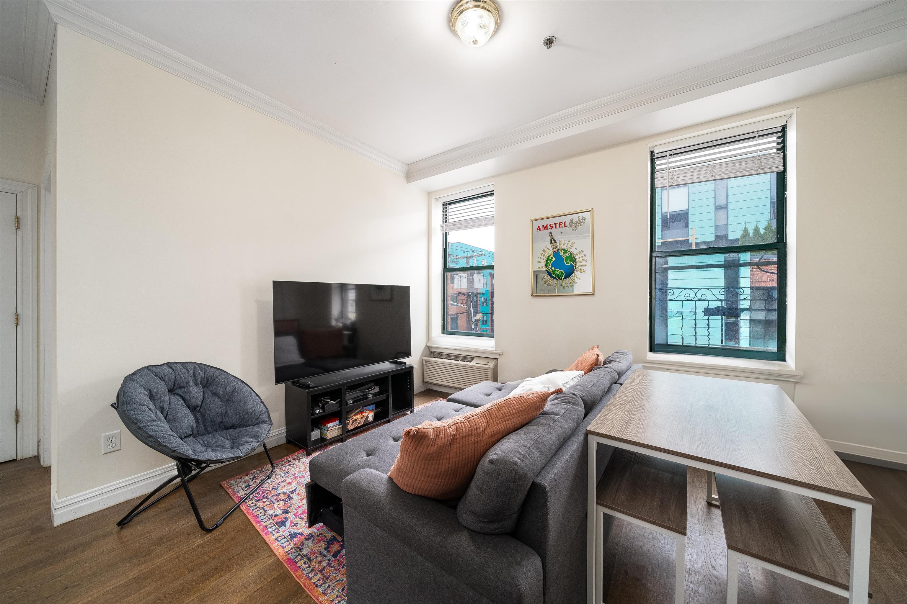 461 4th Street, Unit 3W Hoboken, NJ 07030 - Photo 1 of 12 a living room with furniture and a flat screen tv