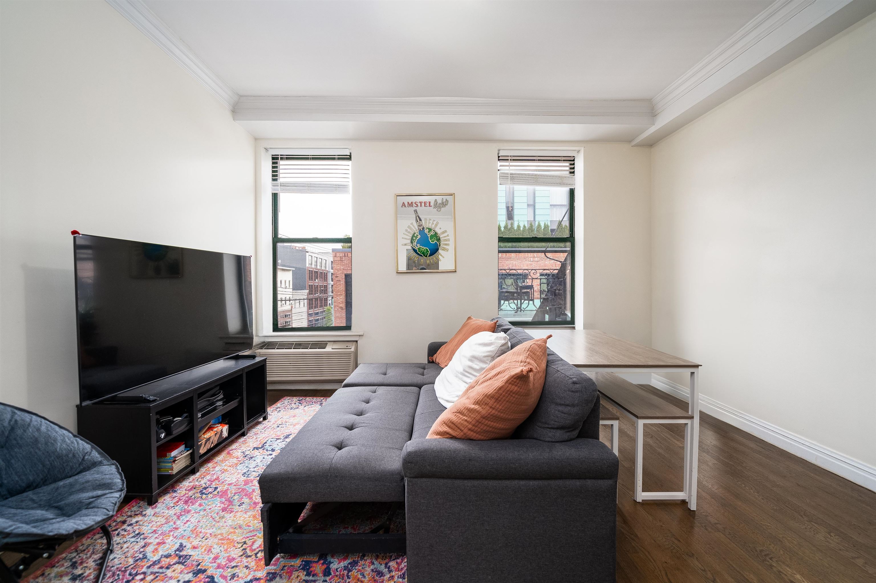 461 4th Street, Unit 3W Hoboken, NJ 07030 - Photo 2 of 12 a living room with furniture and a flat screen tv