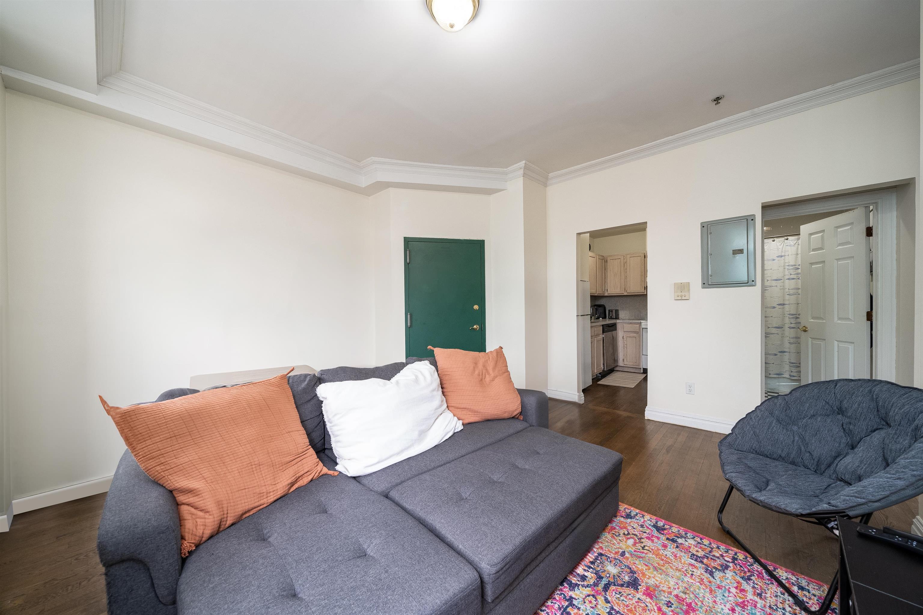 461 4th Street, Unit 3W Hoboken, NJ 07030 - Photo 4 of 12 a living room with furniture and a rug