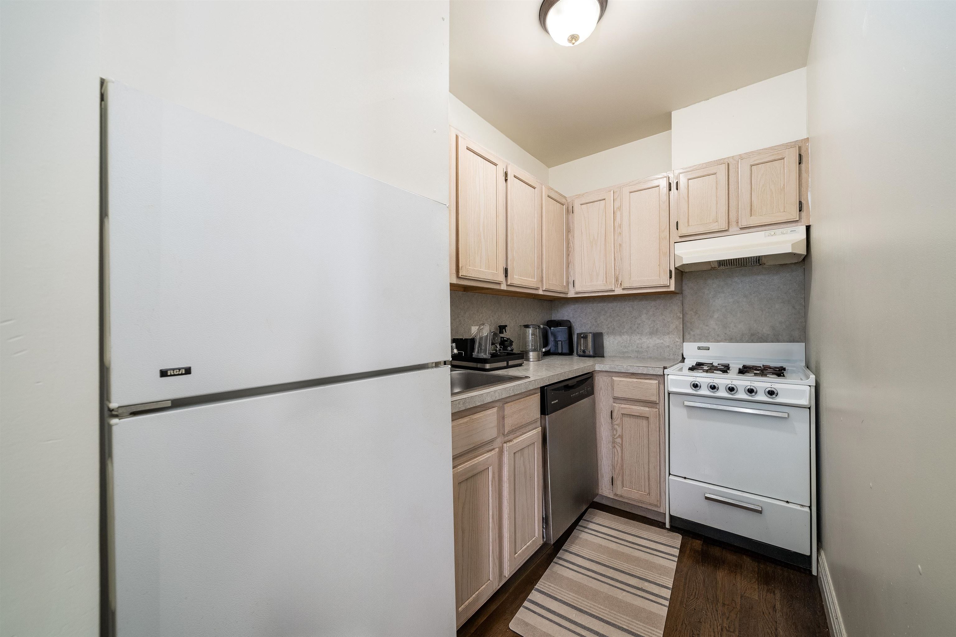 461 4th Street, Unit 3W Hoboken, NJ 07030 - Photo 6 of 12 a kitchen with a white cabinets and white appliances