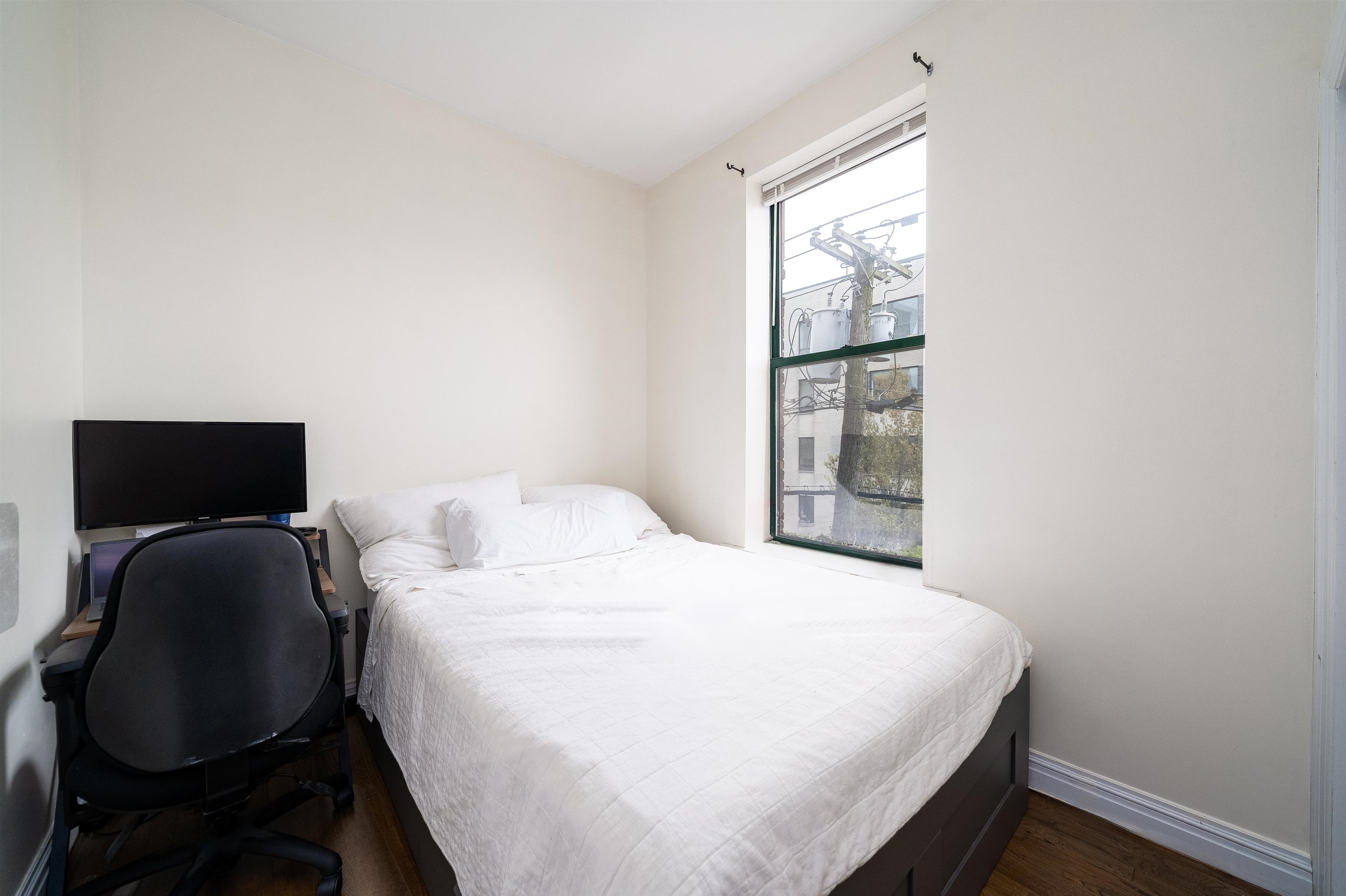 461 4th Street, Unit 3W Hoboken, NJ 07030 - Photo 9 of 12 a bedroom with a bed and a window