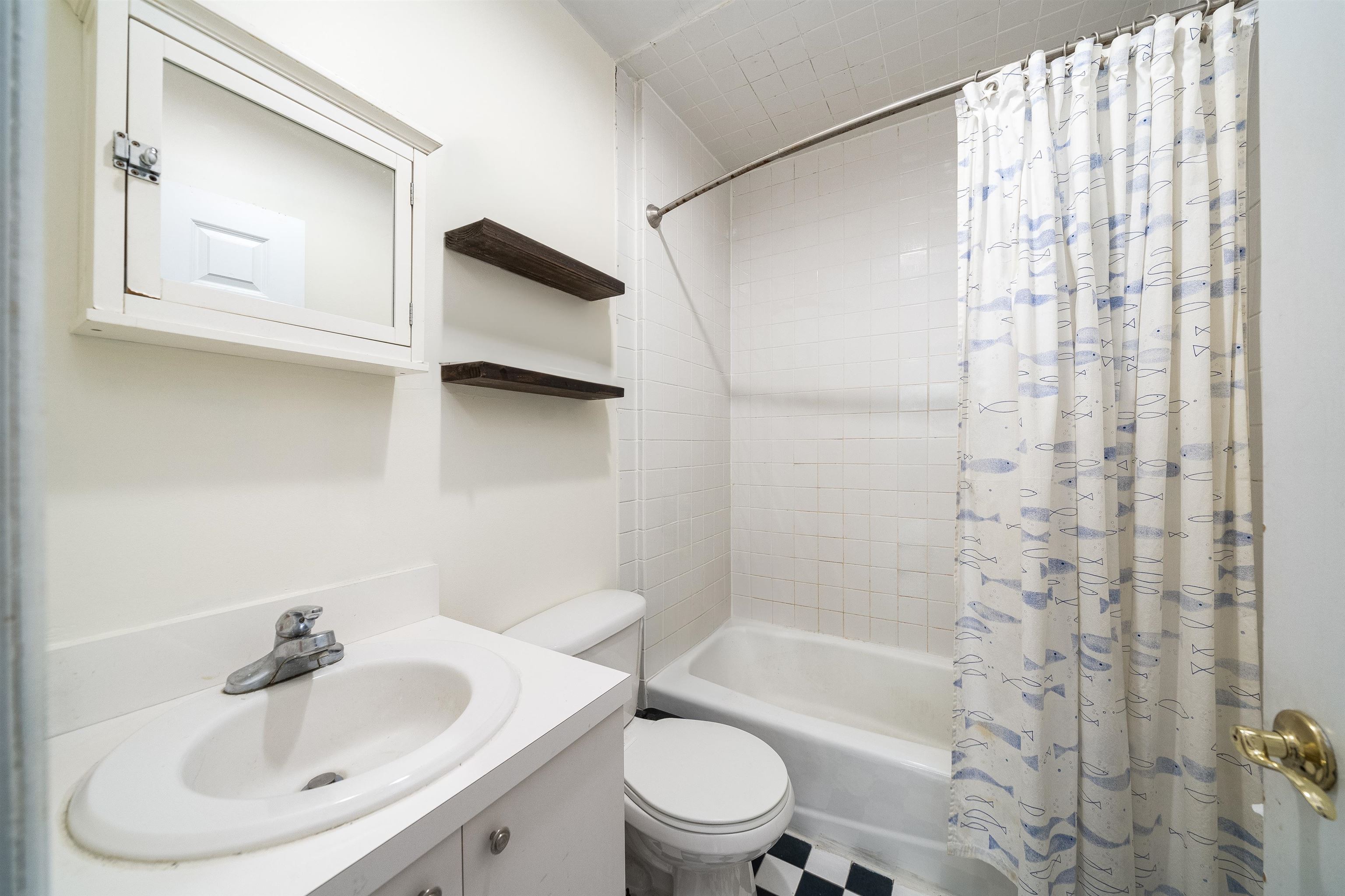 461 4th Street, Unit 3W Hoboken, NJ 07030 - Photo 10 of 12 a bathroom with a sink toilet and shower