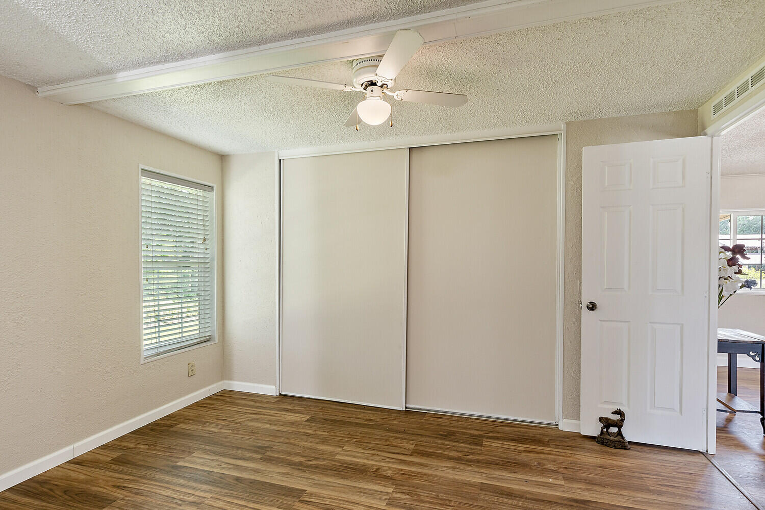 10710 Meadows Road White City, OR 97503 - Photo 17 of 46 a view of an empty room with window and wooden floor