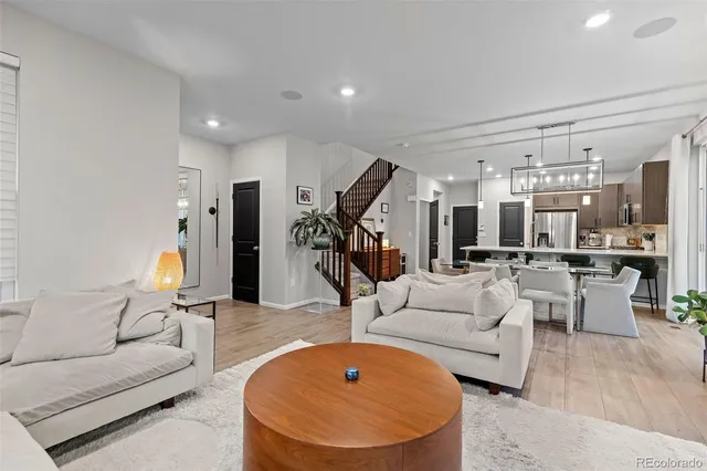 a living room with furniture and a chandelier
