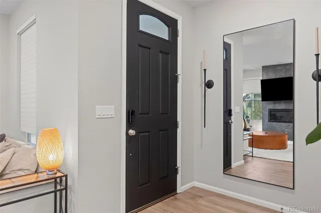 a view of a hallway with bathroom and wooden floor