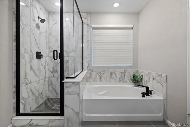 a bathroom with a bathtub and shower