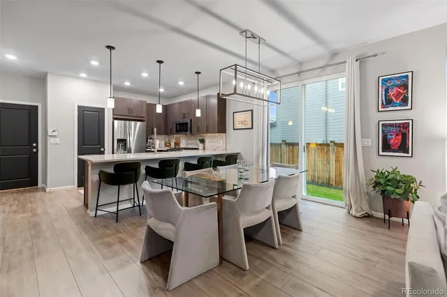 a large kitchen with a table and chairs