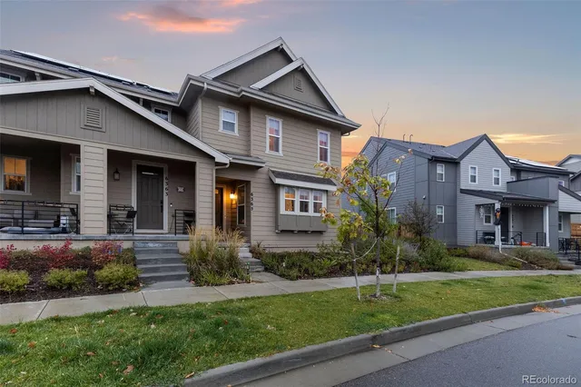 a front view of a house with a yard and porch