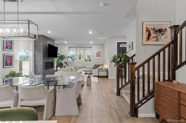 a living room with furniture a flat screen tv and a table