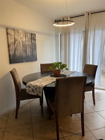 a dining room with furniture and window
