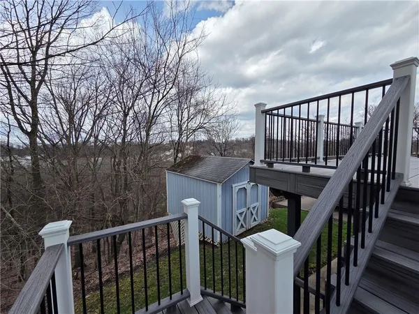 an aerial view of a house with a garden and lake view