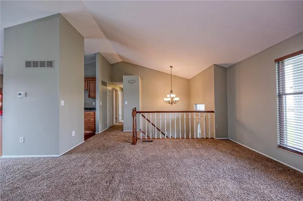 a kitchen with stainless steel appliances granite countertop a sink a stove and a wooden cabinets