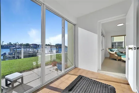a living room with a floor to ceiling window and a table