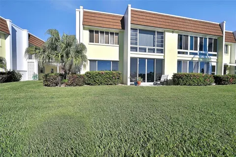 a front view of a building with a yard