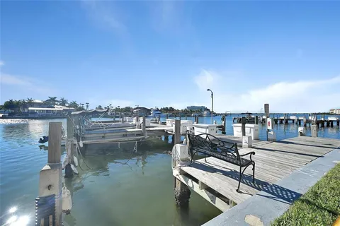 a view of a lake with boats and trees in the background