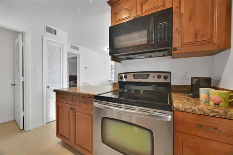 a stove top oven sitting inside of a kitchen
