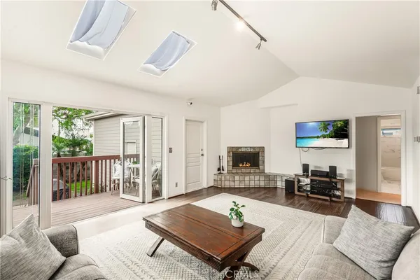 a living room with furniture a rug and a flat screen tv