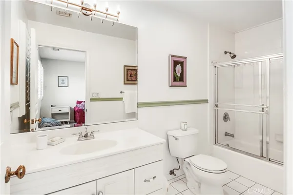a bathroom with a sink toilet vanity and shower