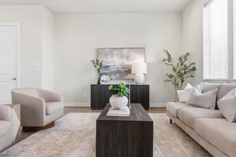 a living room with furniture and flowers