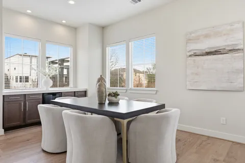 a dining room with furniture and window