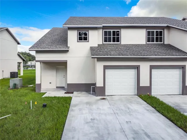 a kitchen with granite countertop a refrigerator and a sink