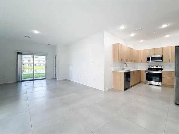 a kitchen with stainless steel appliances a refrigerator and a sink