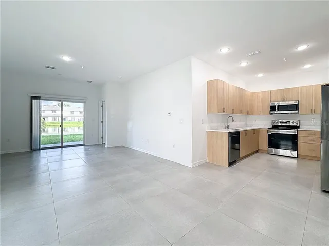 a kitchen with stainless steel appliances a refrigerator and a sink