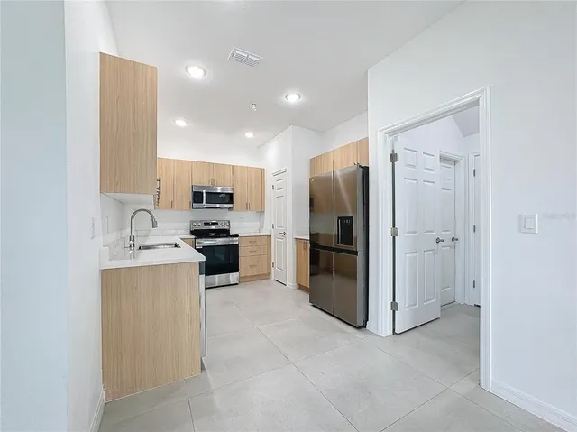 a sink sitting area with wooden cabinets