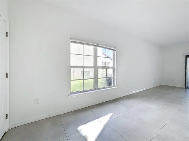 an empty room with windows and entrance