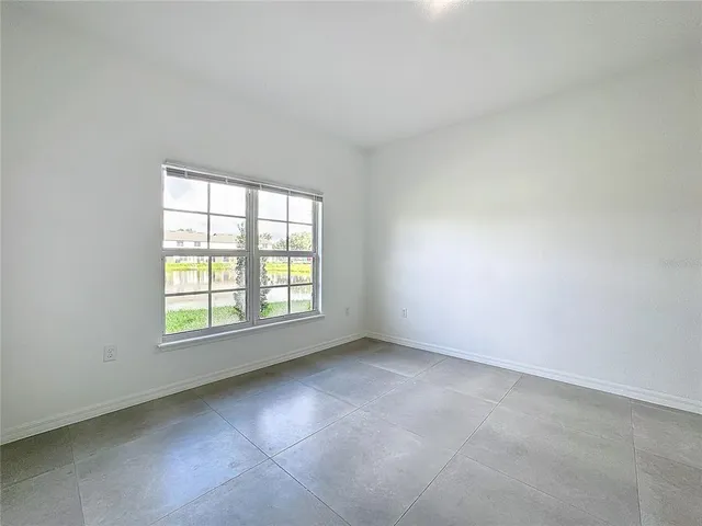 an aerial view of a house with a big yard