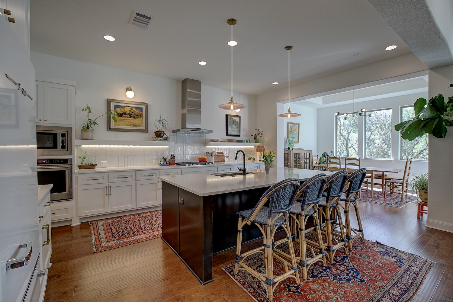 129 Hollytree Court Georgetown, TX 78628 - Photo 20 of 40 a kitchen with stainless steel appliances granite countertop a table chairs sink refrigerator and microwave