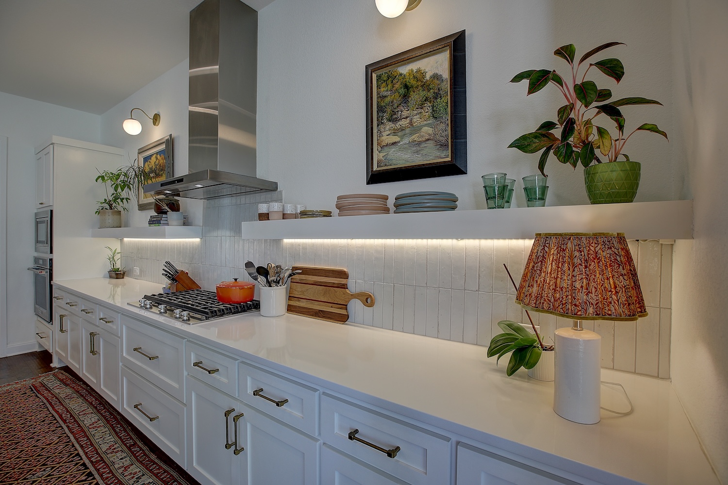 129 Hollytree Court Georgetown, TX 78628 - Photo 22 of 40 a kitchen with a potted plant on the counter and cabinets