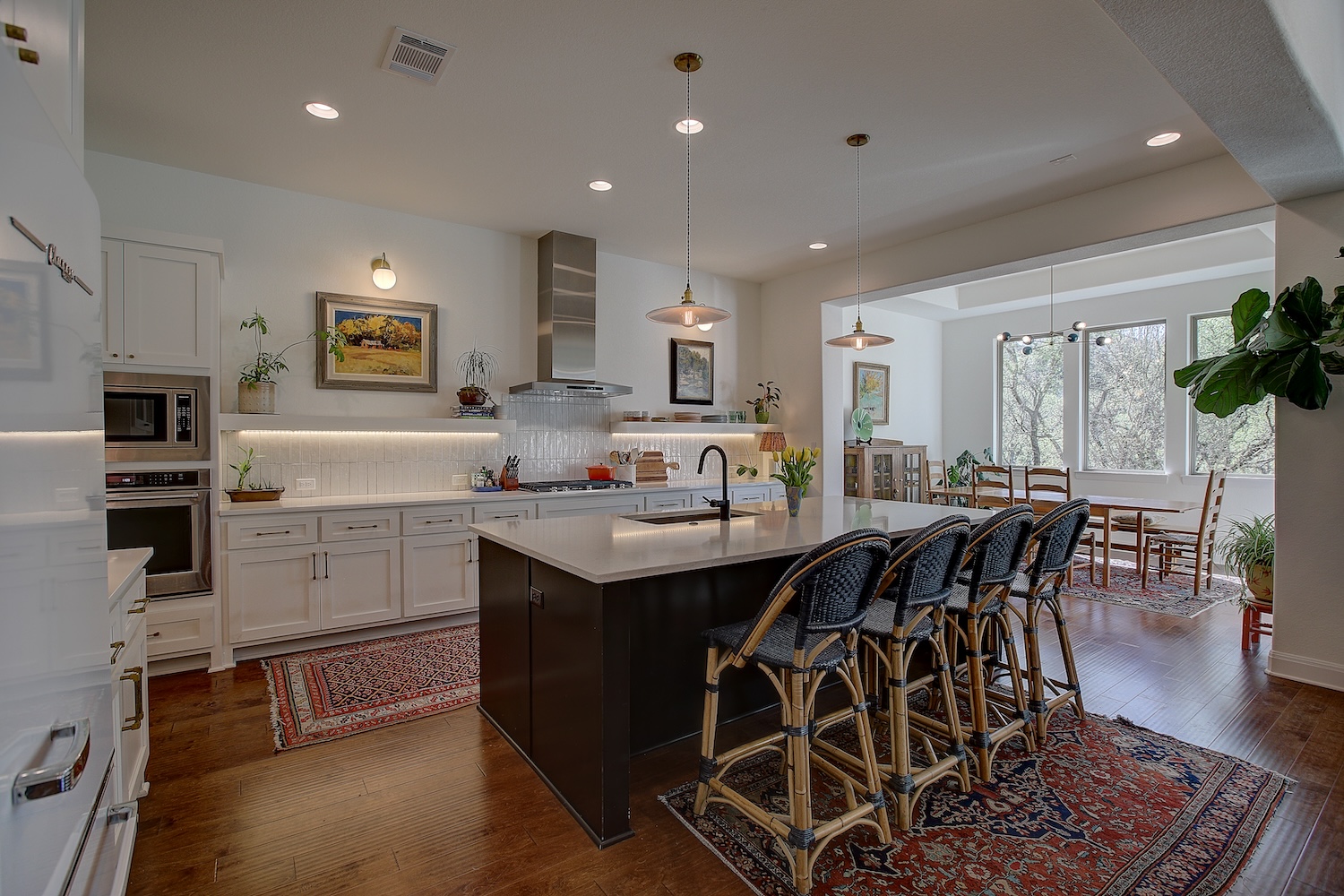 129 Hollytree Court Georgetown, TX 78628 - Photo 23 of 40 a kitchen with stainless steel appliances granite countertop a sink a stove a dining table and chairs