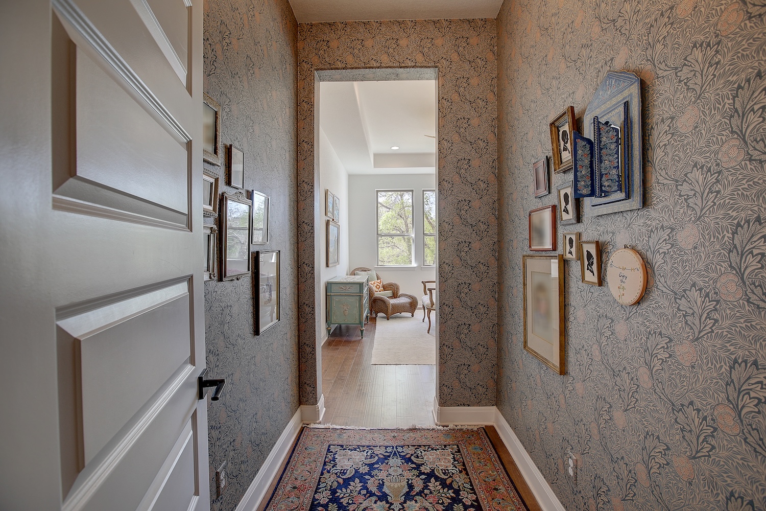 129 Hollytree Court Georgetown, TX 78628 - Photo 28 of 40 Leading to the primary suite, this hallway has designer wallpaper. A great transition space from the common area to the private primary suite