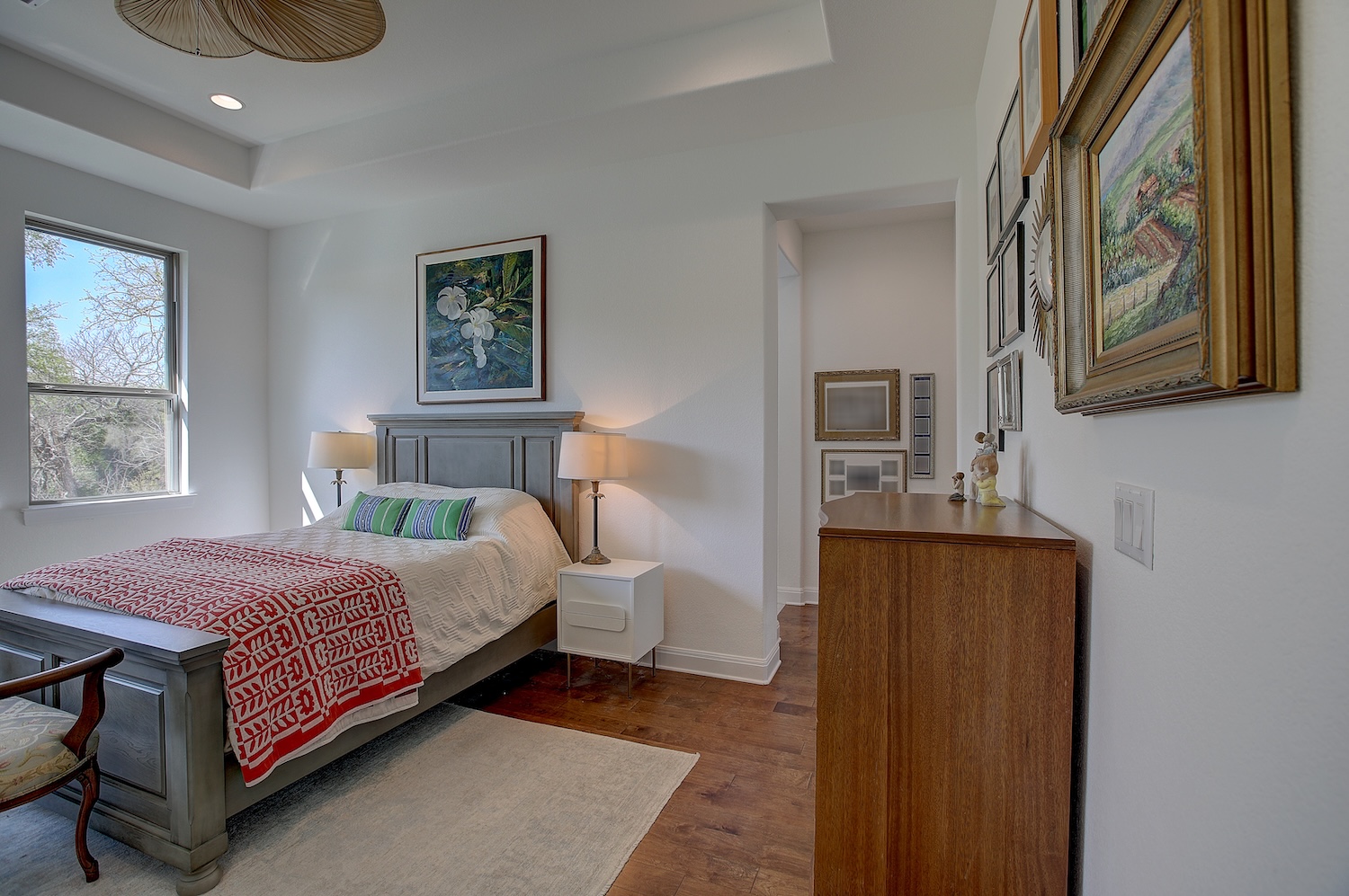 129 Hollytree Court Georgetown, TX 78628 - Photo 30 of 40 a bedroom with a bed and wooden floor