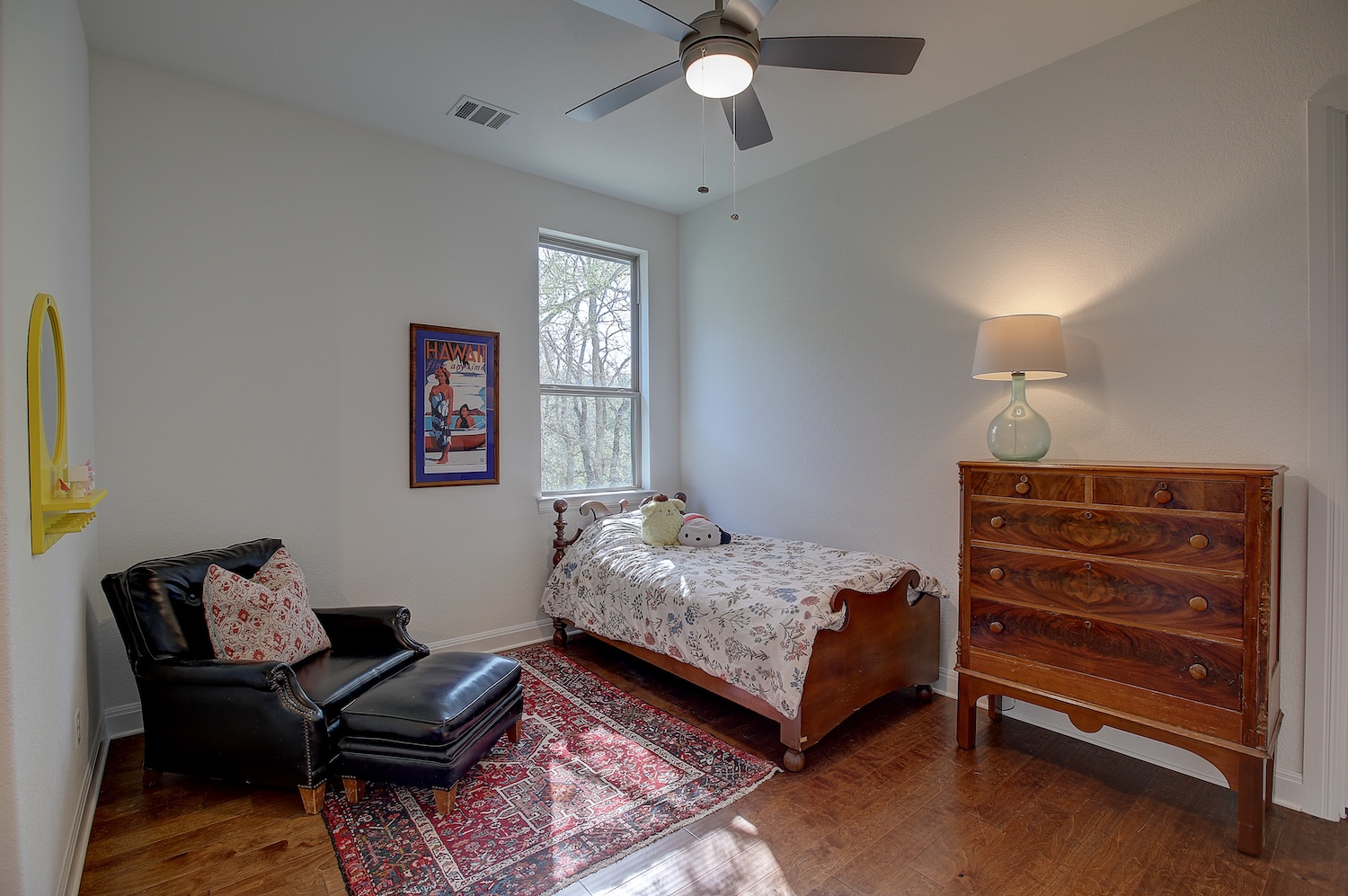 129 Hollytree Court Georgetown, TX 78628 - Photo 34 of 40 a bedroom with a bed and a chandelier