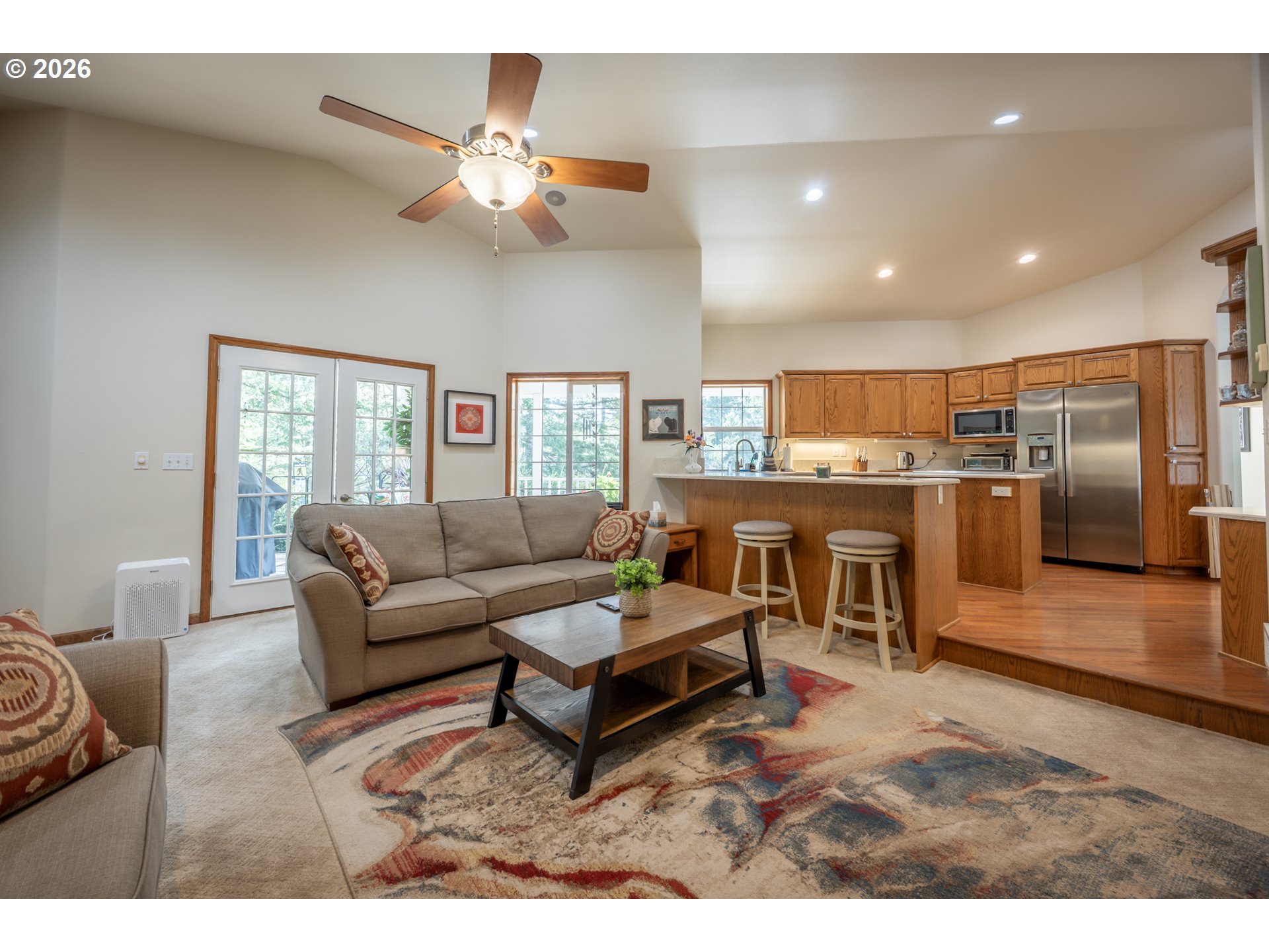 2193 13th Street Florence, OR 97439 - Photo 26 of 48 a living room with a couch kitchen view and a chandelier