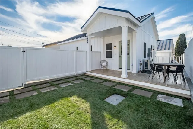 a backyard of a house with table and chairs