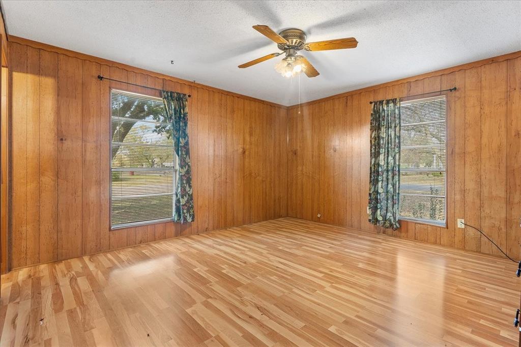 519 Tolson Avenue Van Alstyne, TX 75495 - Photo 12 of 25 a view of an empty room with a window and wooden floor
