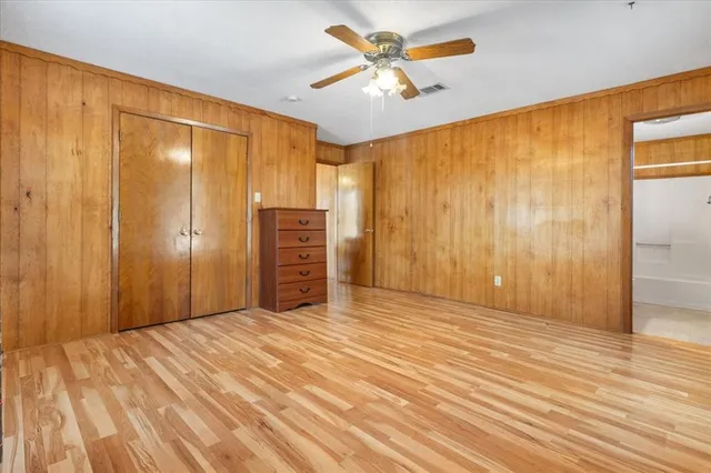 an empty room with closet and entryway