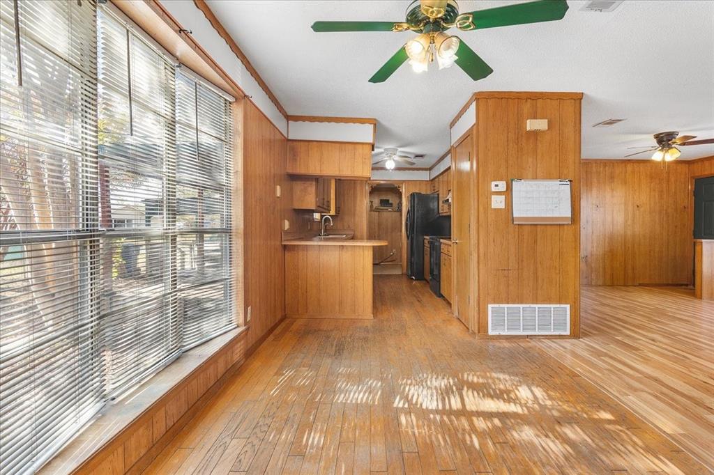 519 Tolson Avenue Van Alstyne, TX 75495 - Photo 7 of 25 a view of a kitchen with a fridge and wooden floor