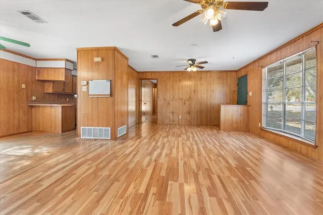 a spacious bedroom with a bed and a chandelier